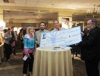 Barbara Cohen, Committee member, and Ken Salzman giving a check to Roland Curtis of the Boys and Girls Club of Kingston at the 2012 Fall for Art