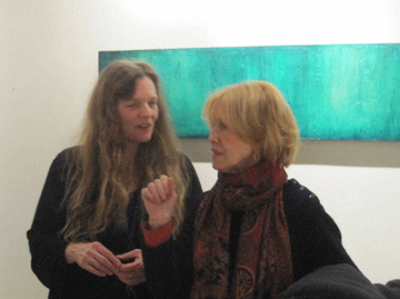 Julie Hedricks (L) speaking with one of her collectors about the new paintings that are on view at R&F Encaustics in Kingsotn, NY