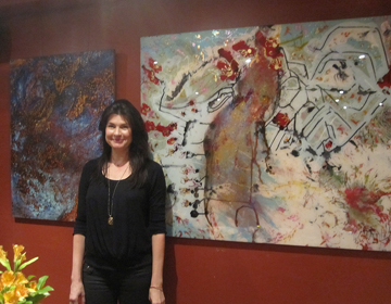 Sara Conca standing by one of her acrylic on acrylic paintings  at Oriole9 Gallery, Woodstock, NY