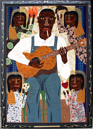 A large work of a blues singer titled “The Blues Saved My Life” illustrates the artist’s enjoyment of this musical genre.